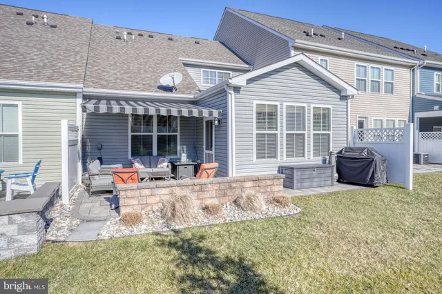 a view of a house with backyard porch and sitting area
