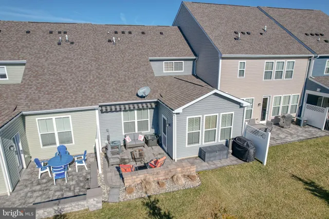 a front view of a house with outdoor seating