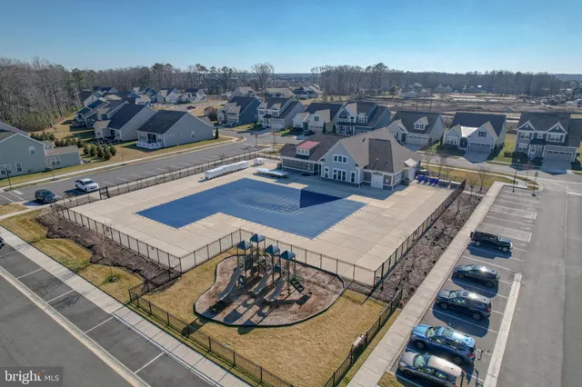 a view of a big house with a big yard and large trees