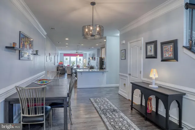 a view of a dining room with furniture and a chandelier