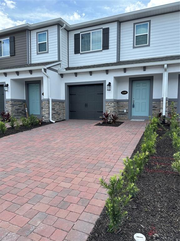 a front view of a house with a yard and a garage