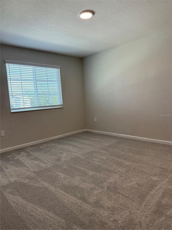 4409 Campsite Loop Orlando, FL 32824 - Photo 13 of 32 an empty room with a window