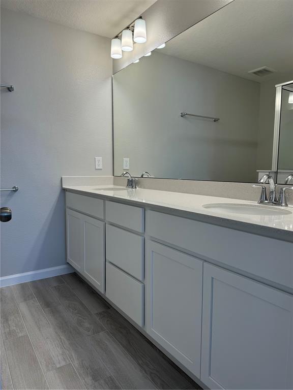 4409 Campsite Loop Orlando, FL 32824 - Photo 14 of 32 a bathroom with a sink and a mirror