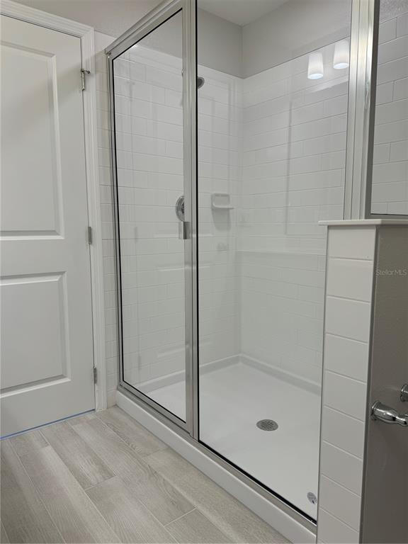 4409 Campsite Loop Orlando, FL 32824 - Photo 15 of 32 a bathroom with a glass shower door