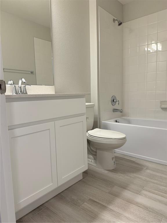 4409 Campsite Loop Orlando, FL 32824 - Photo 19 of 32 a bathroom with a toilet a sink and bathtub