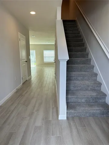 a view of entryway and hall with wooden floor