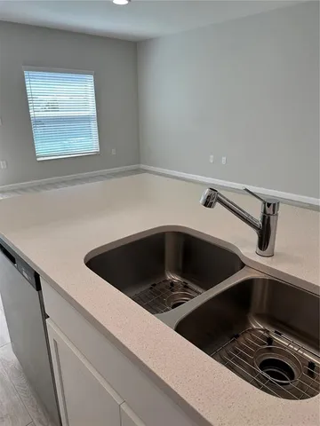 a kitchen with a sink cabinets and window