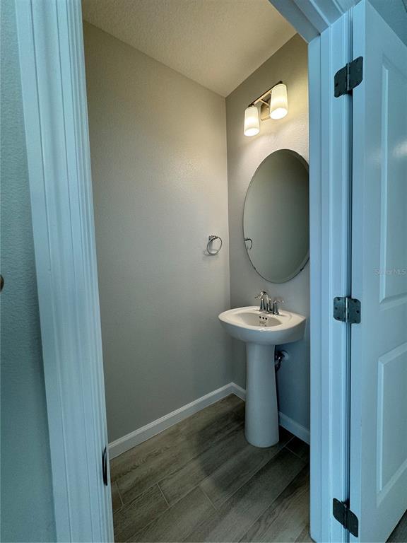 4409 Campsite Loop Orlando, FL 32824 - Photo 10 of 32 a bathroom with a sink toilet and a mirror