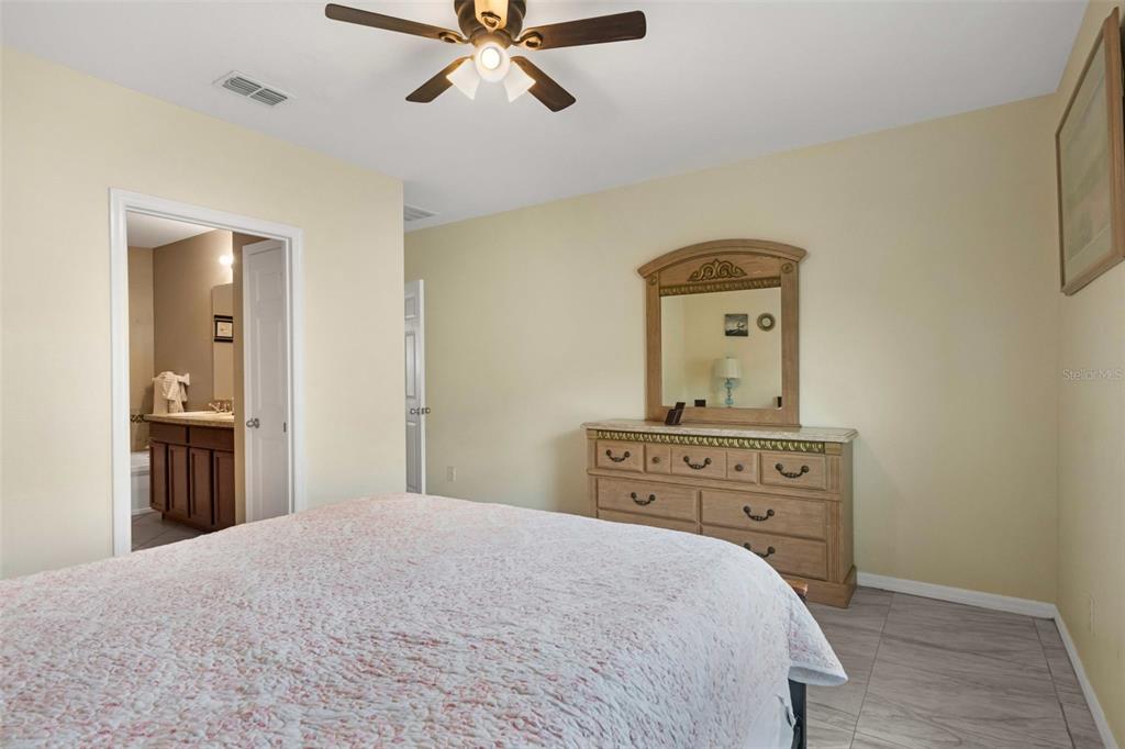 540 Vitoria Road Davenport, FL 33837 - Photo 13 of 21 a bedroom with a bed and cabinets