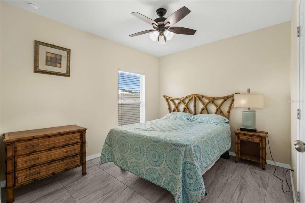 540 Vitoria Road Davenport, FL 33837 - Photo 17 of 21 a bedroom with a bed and a chandelier