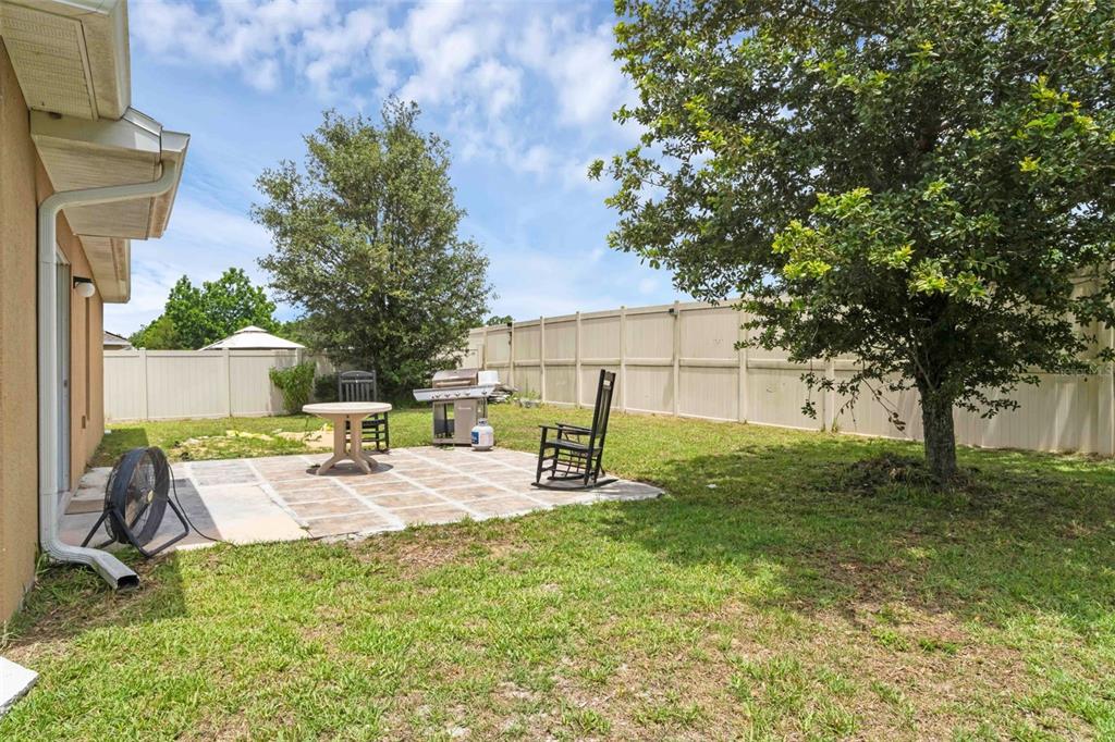 540 Vitoria Road Davenport, FL 33837 - Photo 20 of 21 a view of a backyard with a sitting area