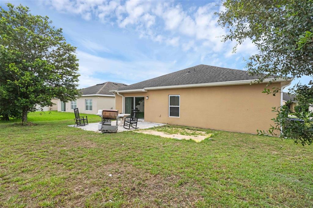 540 Vitoria Road Davenport, FL 33837 - Photo 21 of 21 a view of a house with backyard and sitting area