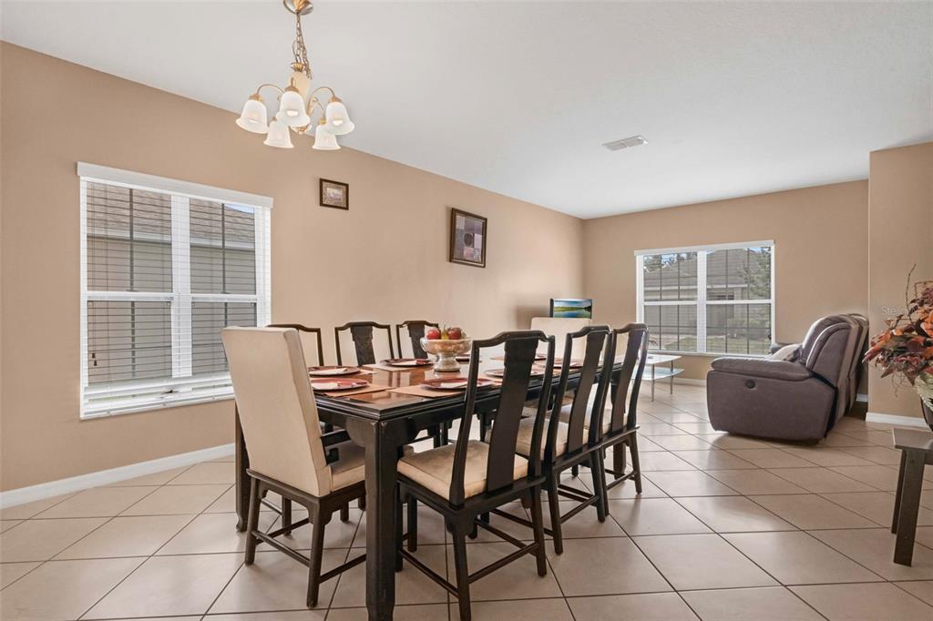 540 Vitoria Road Davenport, FL 33837 - Photo 4 of 21 a view of a dining room with furniture window and outside view
