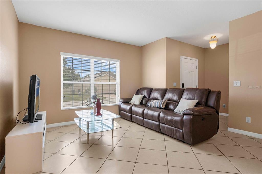 540 Vitoria Road Davenport, FL 33837 - Photo 5 of 21 a living room with furniture and a flat screen tv