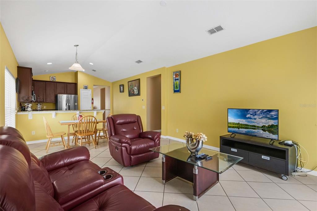 540 Vitoria Road Davenport, FL 33837 - Photo 8 of 21 a living room with furniture and a flat screen tv