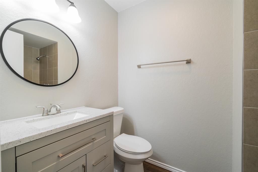 3604 Biscay Drive Arlington, TX 76016 - Photo 13 of 18 a bathroom with a sink a toilet and a mirror