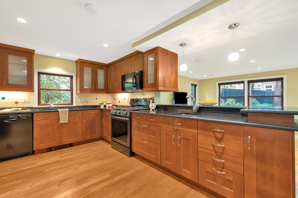 5 Grandview Road Arlington, MA 02476 - Photo 16 of 42 a kitchen with stainless steel appliances granite countertop a stove sink and cabinets