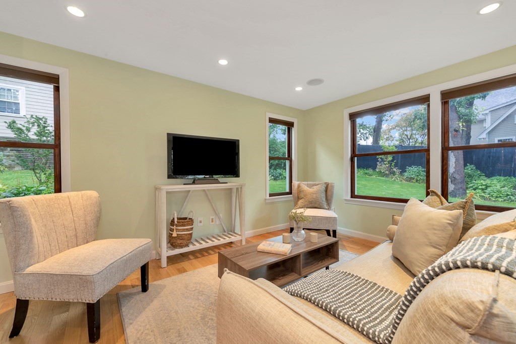 5 Grandview Road Arlington, MA 02476 - Photo 25 of 42 a living room with furniture a flat screen tv and a floor to ceiling window