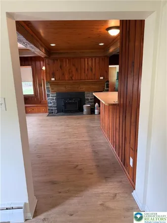 a view of a hallway with wooden floor and furniture