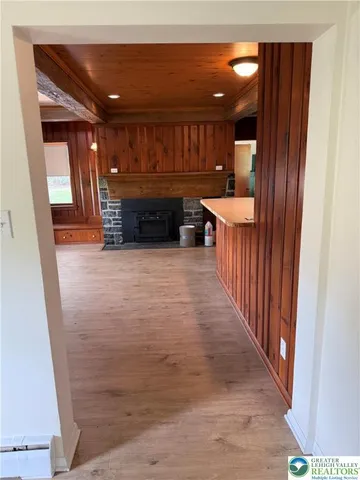 a view of a hallway with wooden floor and furniture