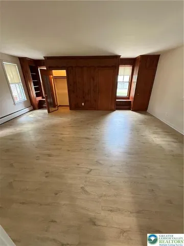 a view of an empty room with windows