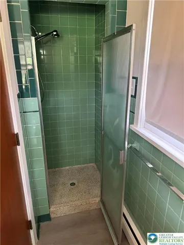 a bathroom with a shower and a sink