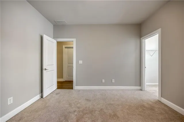 a view of an empty room and closet area