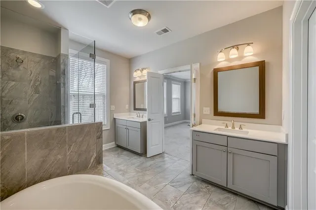 a bathroom with a tub sink and mirror