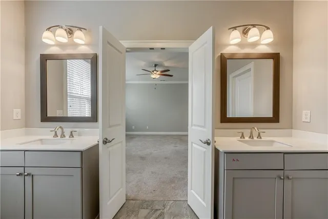 a bathroom with a double vanity sink and a mirror