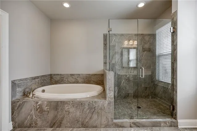 a bathroom with a bathtub and shower