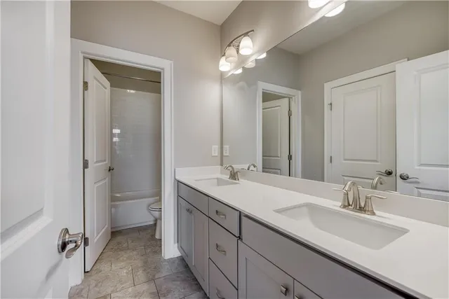 a bathroom with a double vanity sink mirror and double