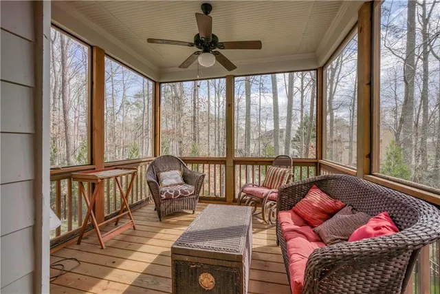 a living room with furniture and floor to ceiling windows