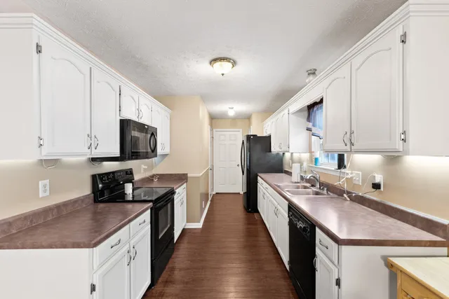 a kitchen with stainless steel appliances a stove sink microwave and cabinets