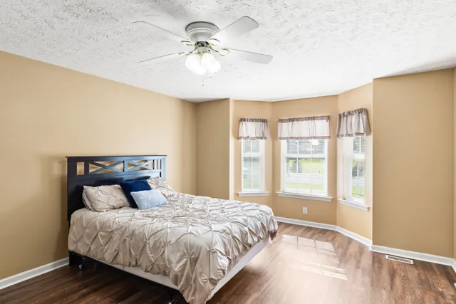 a bedroom with a large bed and a chandelier
