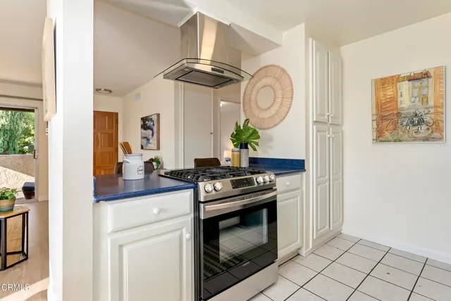 a kitchen with stainless steel appliances granite countertop a stove a washer and dryer