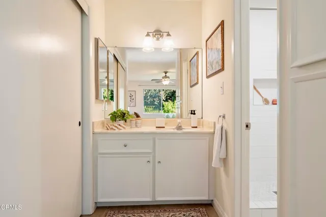 a bathroom with a sink and mirror with toilet