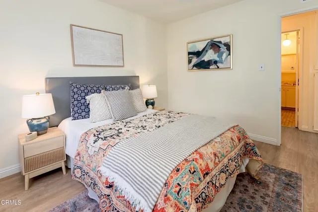 a bedroom with bed and painting on the wall