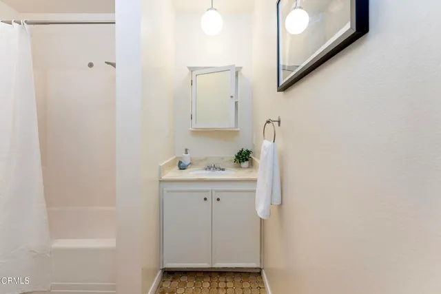 a bathroom with a sink and shower