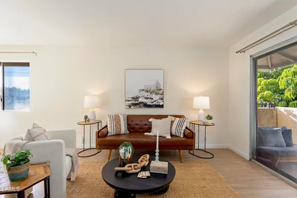 a living room with furniture and a lamp