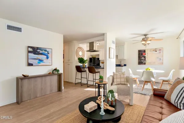 a living room with furniture and a wooden floor