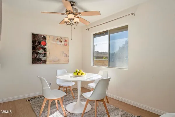 a view of a dining room with furniture wooden floor and a chandelier