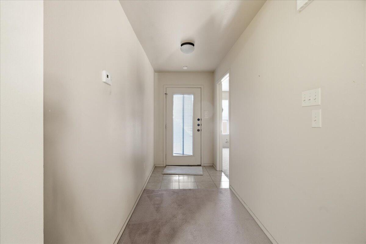 3118 113th Street Lubbock, TX 79423 - Photo 11 of 21 a view of a hallway with wooden floor and a bathroom
