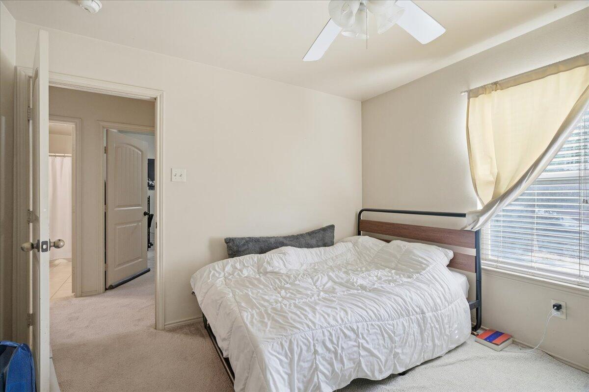 3118 113th Street Lubbock, TX 79423 - Photo 14 of 21 a bedroom with a bed and a window