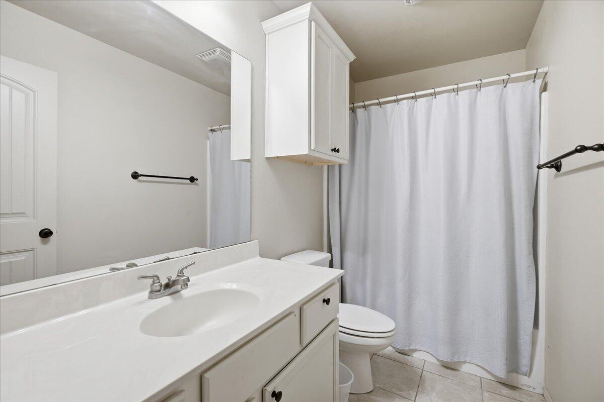 3118 113th Street Lubbock, TX 79423 - Photo 17 of 21 a bathroom with a sink toilet and shower