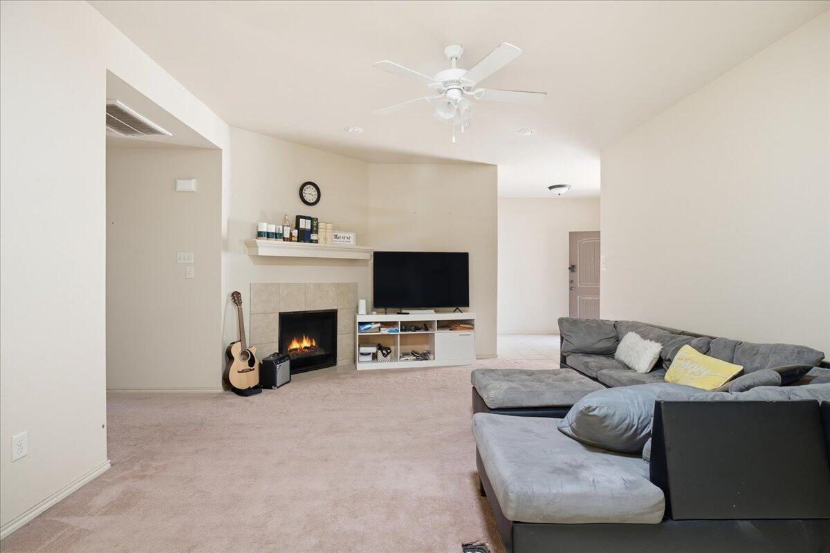 3118 113th Street Lubbock, TX 79423 - Photo 4 of 21 a living room with furniture and a fireplace