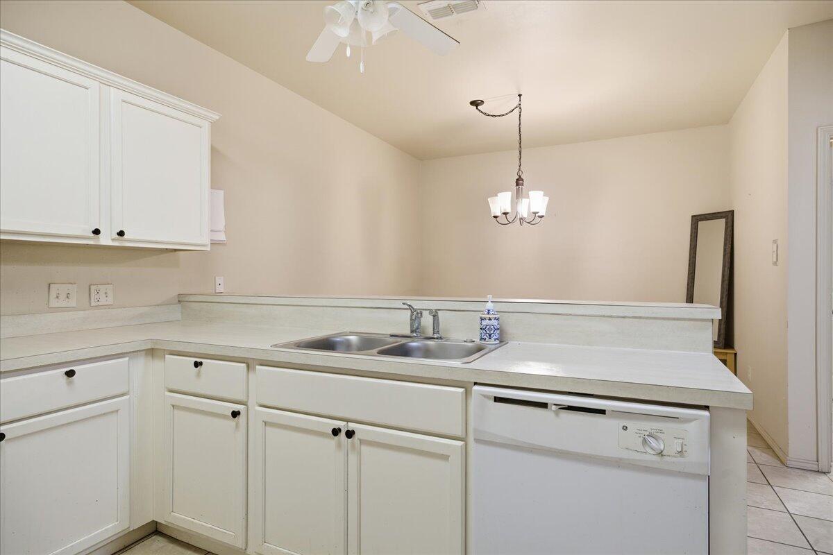 3118 113th Street Lubbock, TX 79423 - Photo 8 of 21 a kitchen with a sink dishwasher and white cabinets