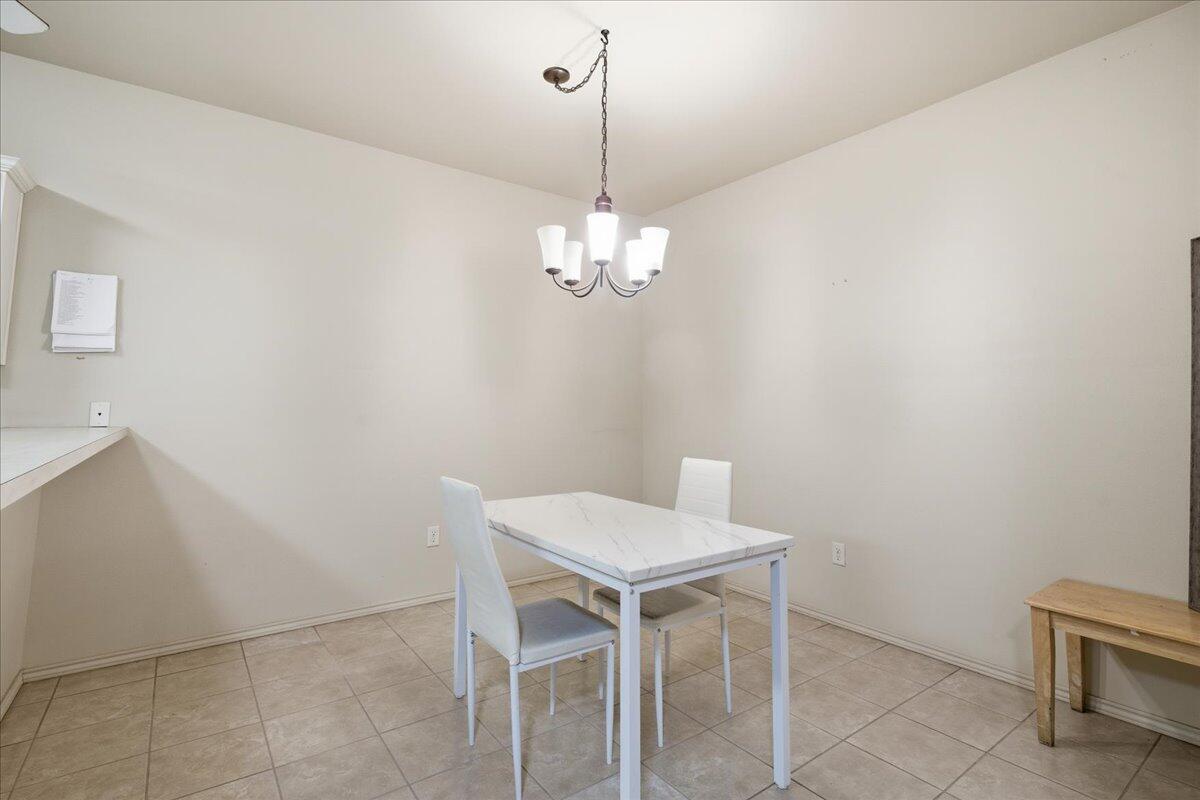 3118 113th Street Lubbock, TX 79423 - Photo 9 of 21 a view of a dining room with furniture and chandelier