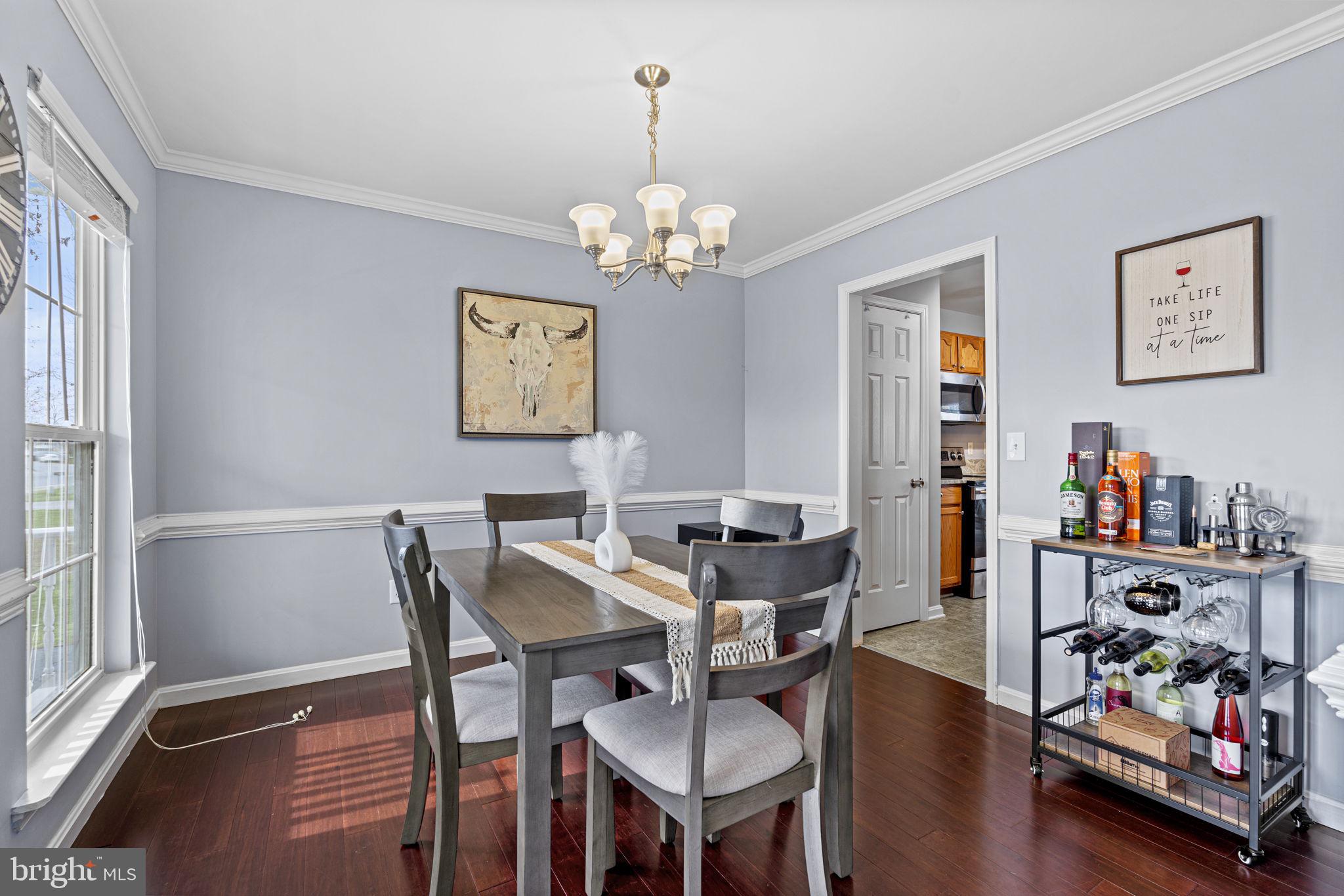 Dining room boasts elegant chair & crown molding