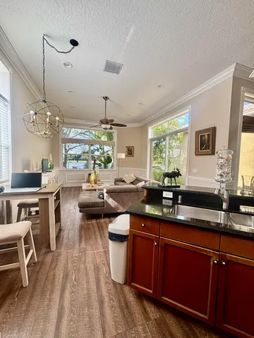 a living room with lots of furniture and view of kitchen