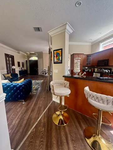 a living room with furniture and wooden floor